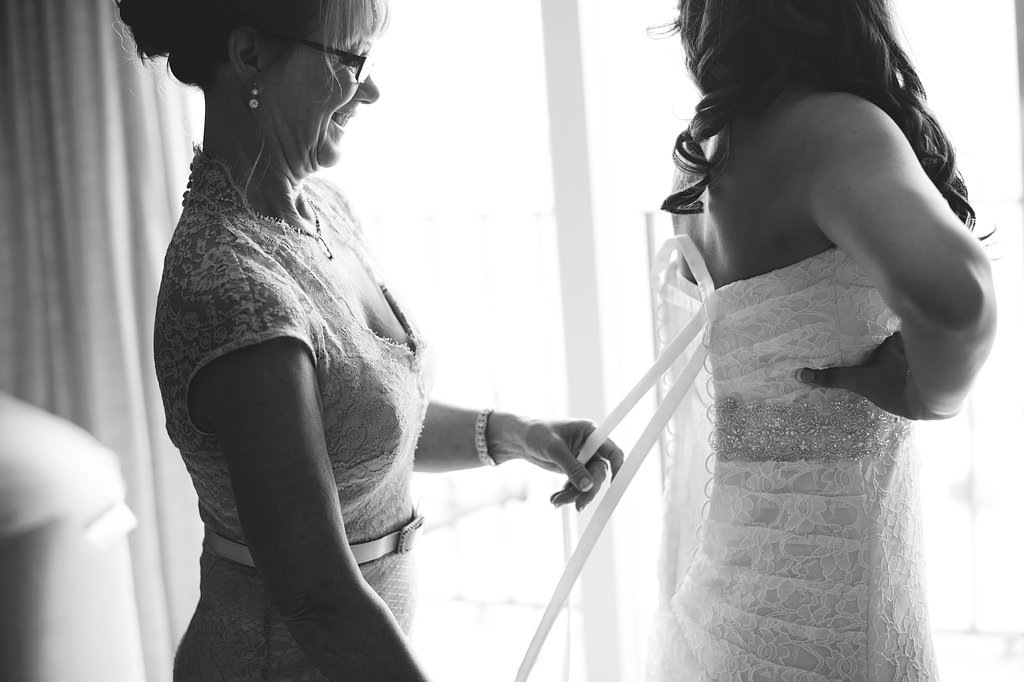 Bride Putting on Wedding Dress