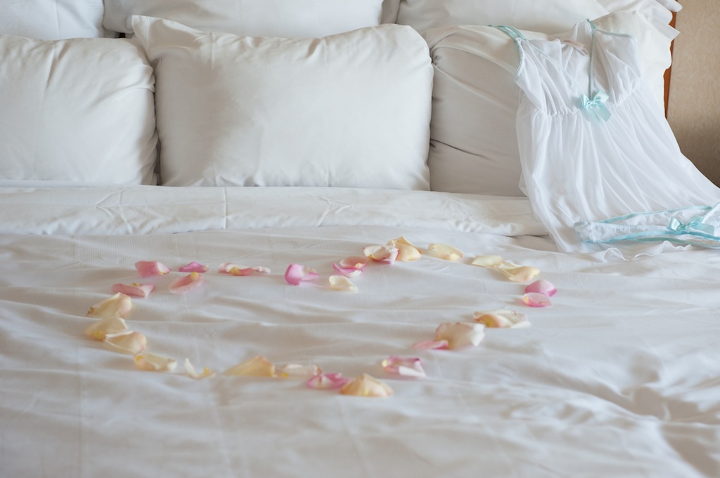 Rose Petals on Bed in Shape of a Heart