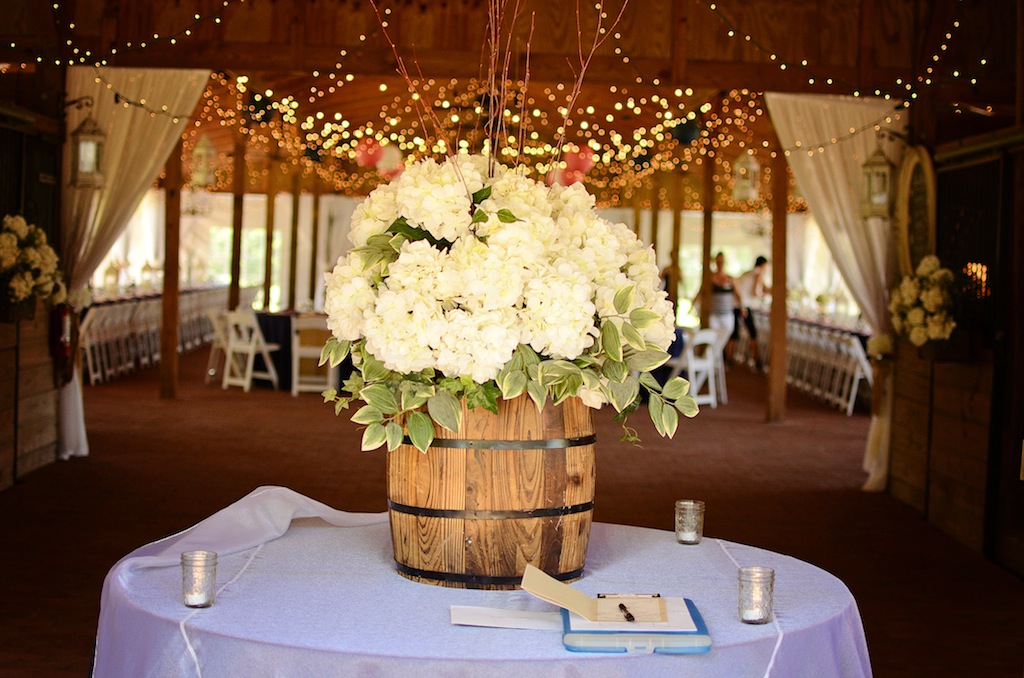 Rustic Wedding Guestbook Sign in Book Table with White Flowers in Barrel