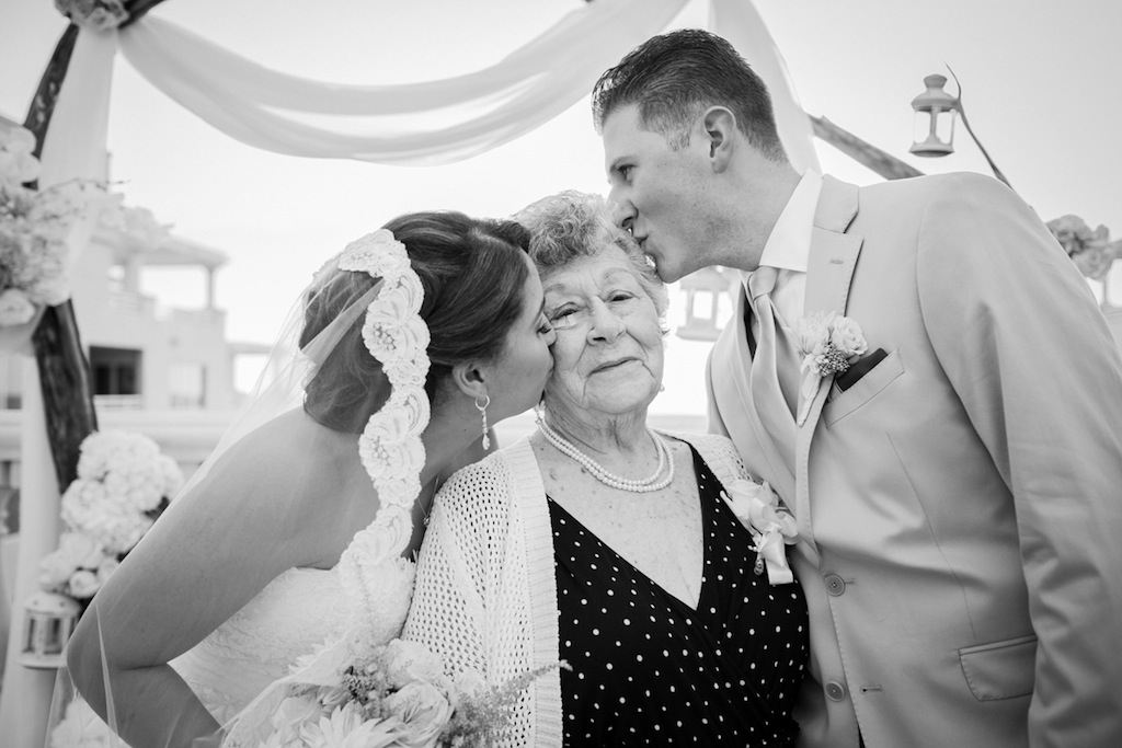 Tampa Bay Bride and Groom Kissing Grandmother