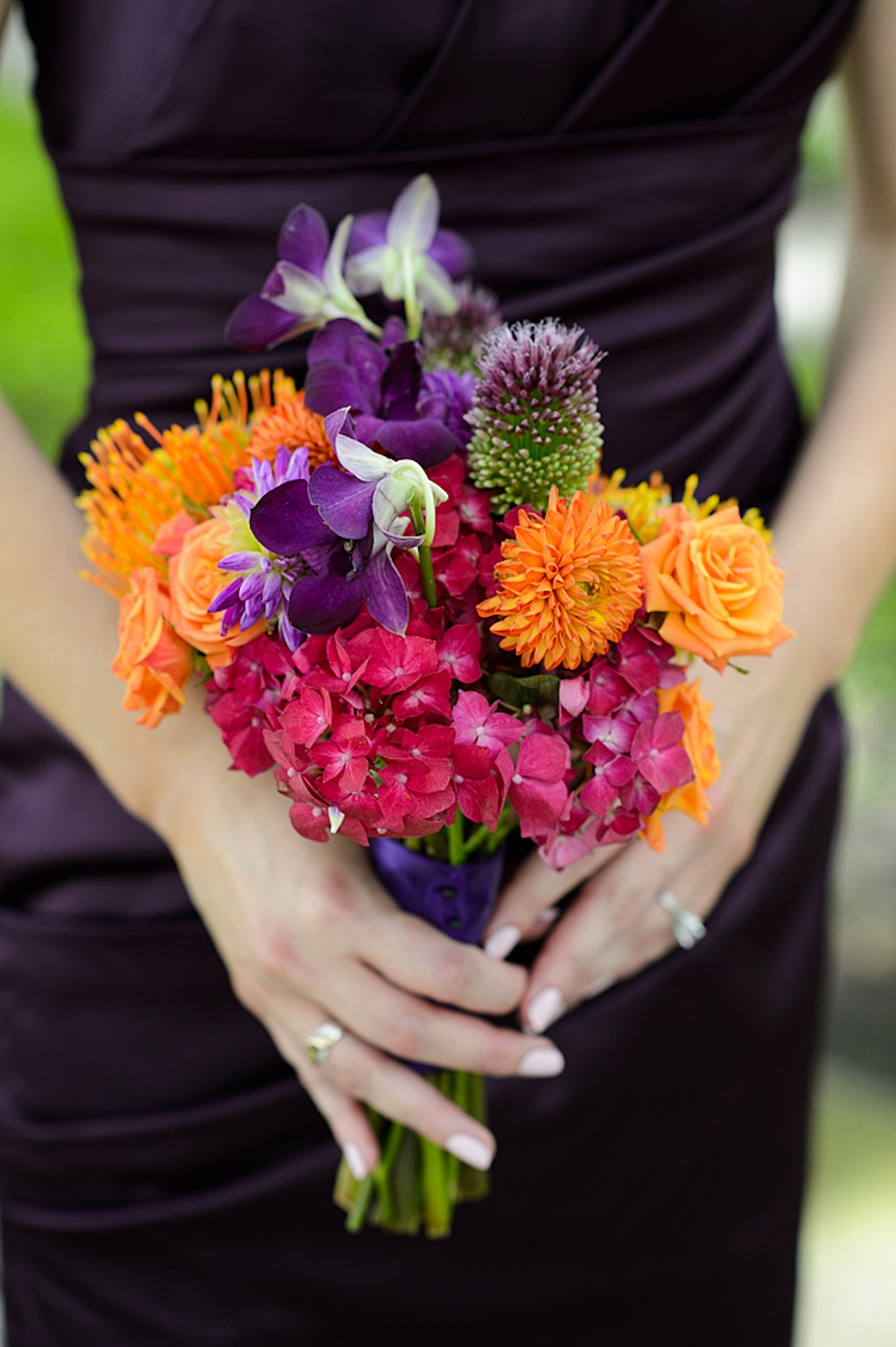 Purple Bridesmaid Dress with Purple and Orange Wedding Bouquet