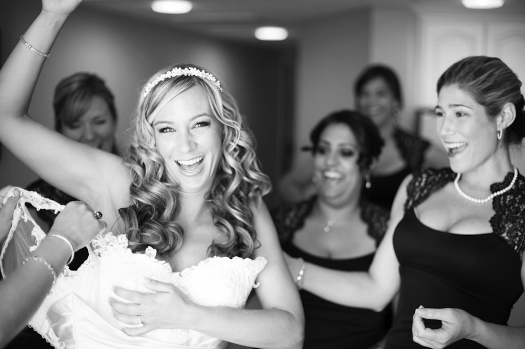 Bride Getting Ready on Wedding Day: Putting on Wedding Dress