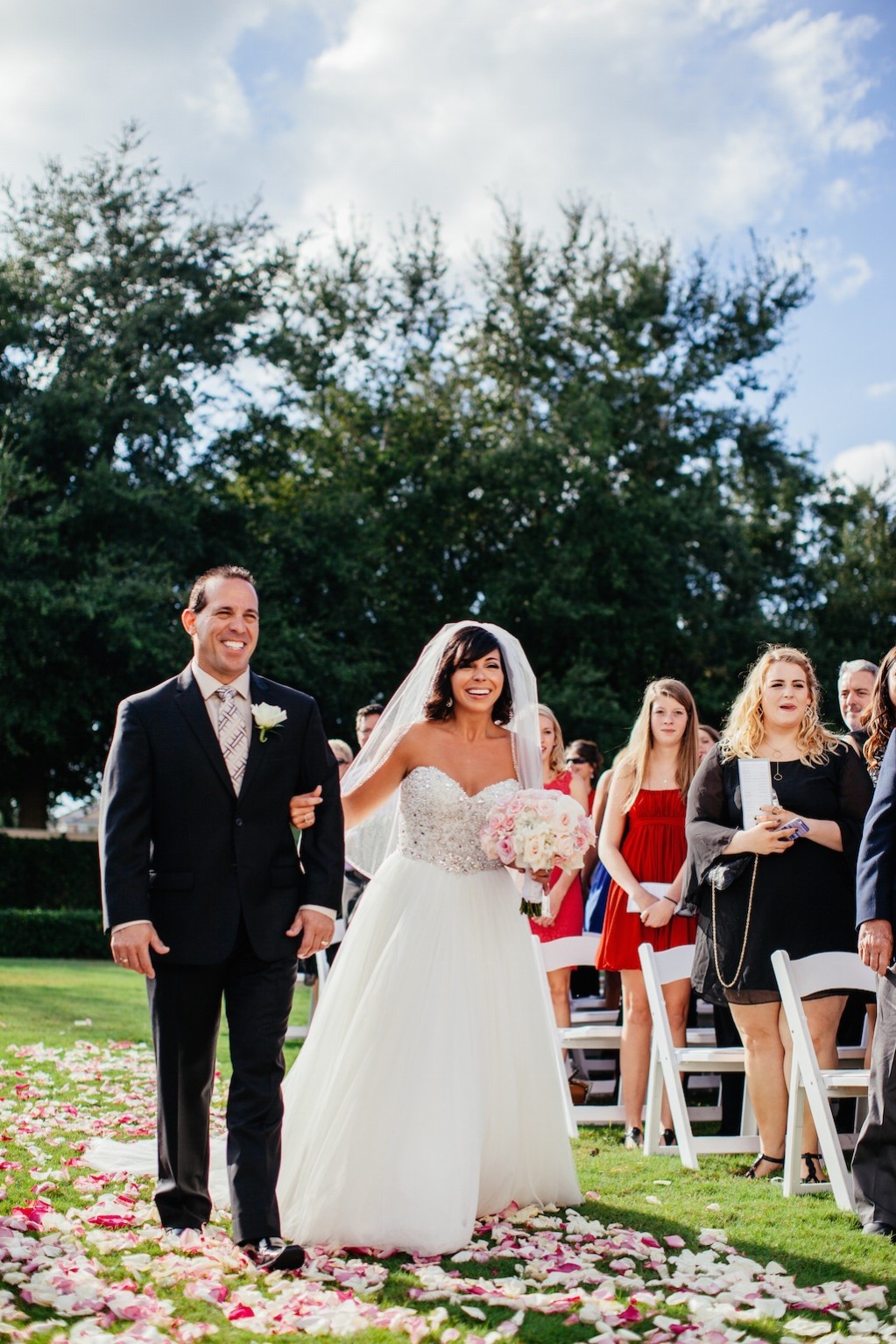 Bride and Father Walking Down Rose Petal Wedding Aisle