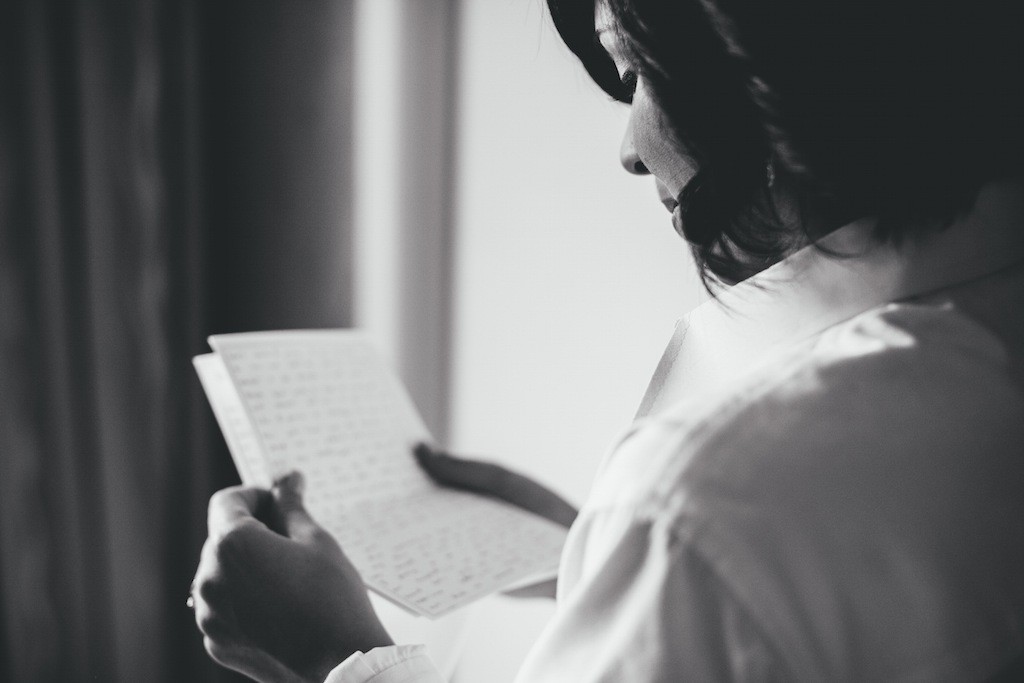 Bride Reading Letter from Groom on Wedding Day