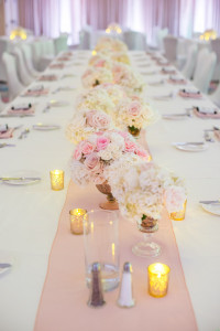 White Wedding Reception with Long Feasting Tables, Pink Runner and Low White and Pink Wedding Centerpieces