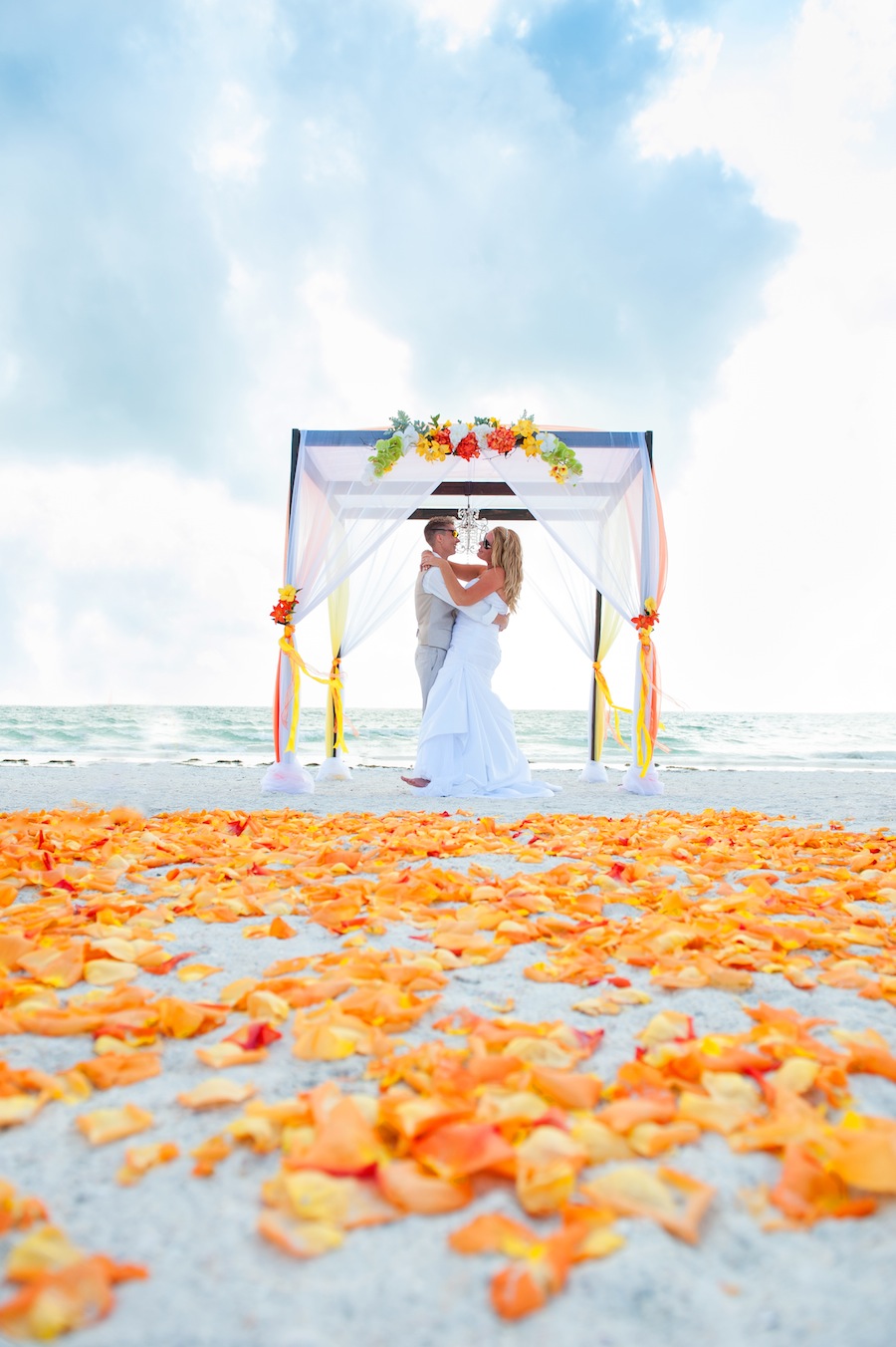 Orange and Red Beach Wedding Ceremony with Wooden Alter and Chandelier | Tide the Knot Beach Weddings