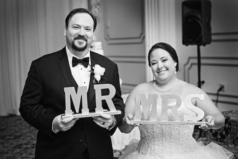 Bride and Groom Holding Mr and Mrs. Wedding Signs