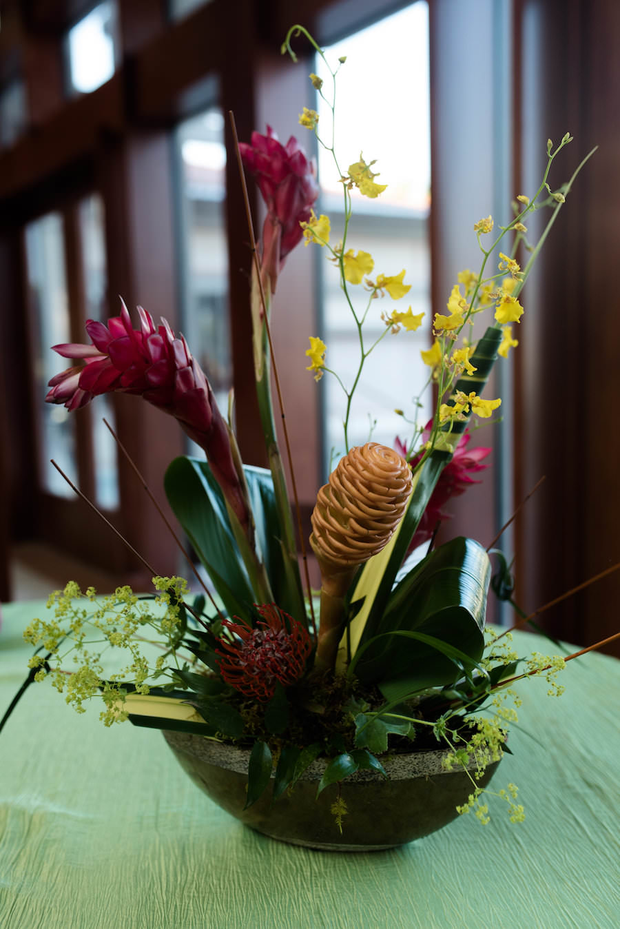 Tropical Orange Wedding Centerpieces with Green Specialty Linen | Coast to Coast Event Rentals | St. Petersburg Wedding Florist Wonderland Floral Art and Gift Loft