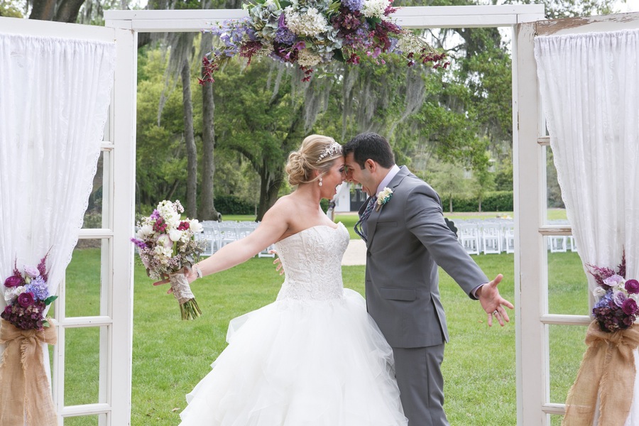 Bride and Groom Celebrating After Wedding Ceremony | Tampa Rustic Wedding Venue Cross Creek Ranch Outdoor Wedding | David's Bridal - Oleg Cassini Wedding Dress