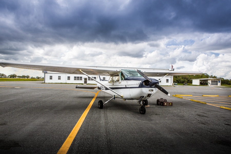 Plane with Vintage Suitcases | Plant City Vintage Airport Engagement Shoot