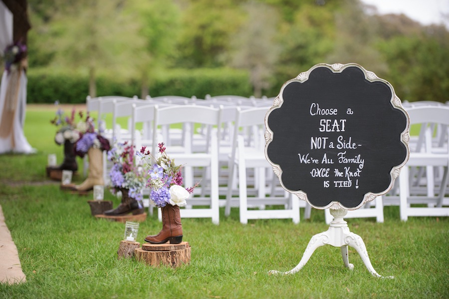Cowboy Boot Wedding Ceremony Decor with Purple Flowers and Chalkboard Sign | Tampa Bay Cross Creek Ranch Wedding