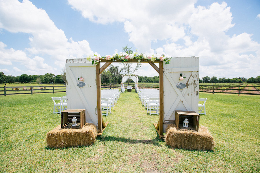 Outdoor Wedding Ceremony Decor with Rustic Doors and Hay Bales | Plant City Wedding Venue Wishing Well Barn