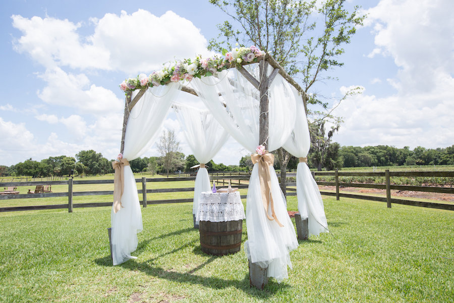 Plant City Outdoor Rustic Wedding Ceremony Altar with Pink and Purple Flowers | Plant City Wedding Venue Wishing Well Barn