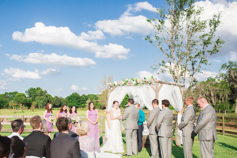 Rustic, Outdoor Wedding Ceremony Bride and Groom Vow Exchange Portrait | Plant City Wedding Venue Wishing Well Barn