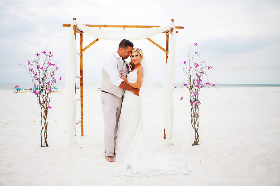 Destination Bride and Groom Beach Wedding Portrait Under Bamboo Altar | Waterfront Wedding Venue Hilton Clearwater Beach | Clearwater Wedding Photographer Limelight Photography