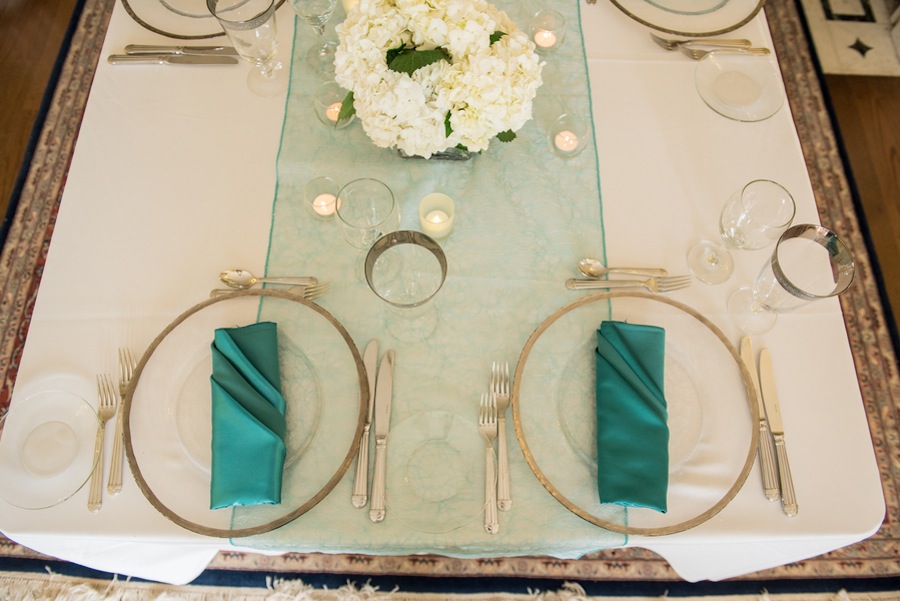 Indoor Sarasota Teal Wedding Reception with Glass Chargers and White Centerpieces