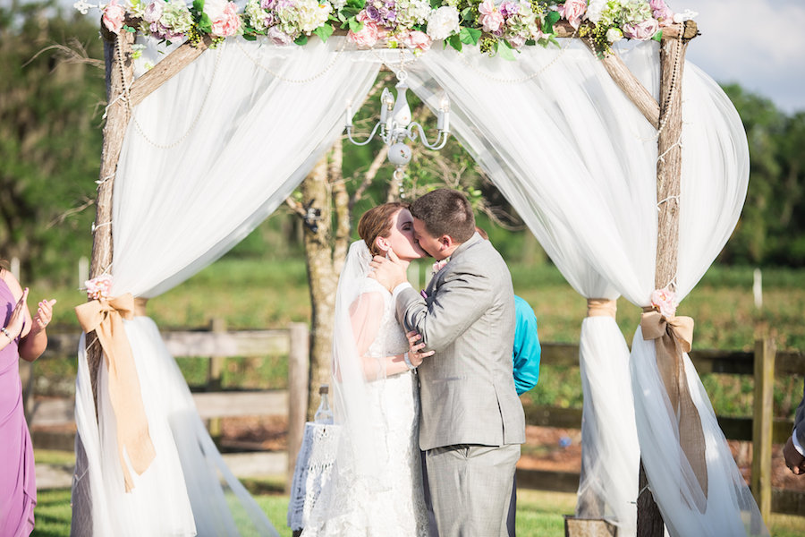 Rustic, Outdoor Wedding Ceremony Bride and Groom First Kiss Portrait | Plant City Wedding Venue Wishing Well Barn