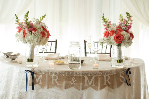 Wedding Reception Sweetheart Table with Burlap Mr. and Mr's Sign and White and Coral Bouquets