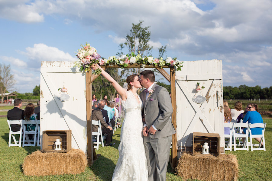 Rustic, Outdoor Wedding Ceremony Bride and Groom Wedding Ceremony Celebration Kiss Portrait | Plant City Wedding Venue Wishing Well Barn