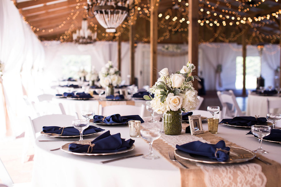 Outdoor Barn Wedding Reception with White Mason Jar Centerpieces and Burlap and Lace Table Runners with Navy Linens | Rustic Tampa Bay Wedding Venue Cross Creek Ranch