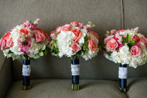 White, Pink, and Coral Wedding Bouquets with Navy Satin Wraps