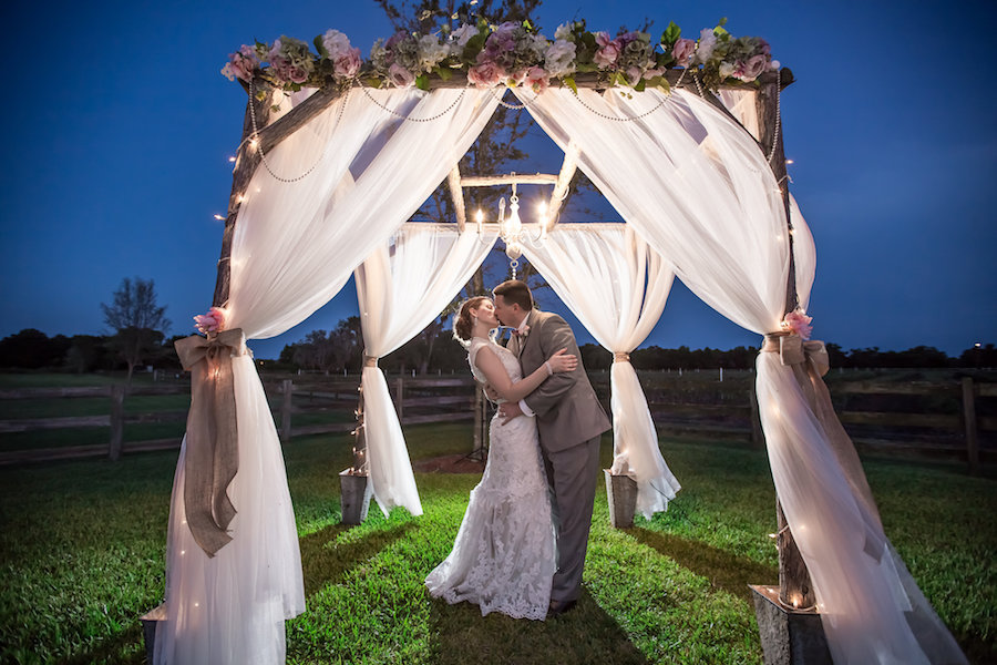 Nighttime, Twilight Bride and Groom Outdoor Wedding Portrait under Wedding Altar | Plant City Wedding Venue Wishing Well Barn | Tampa Wedding Photographer Rad Red Creative