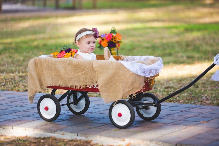 Rustic Wedding Ceremony Flower Girl in Red Wagon