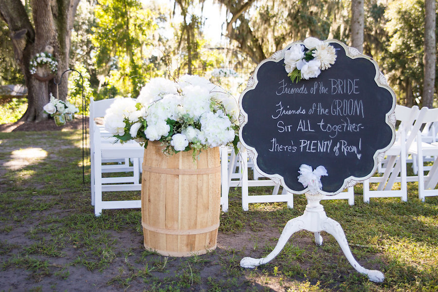 White Wedding Ceremony Floral Decor and Chalkboard Seating Sign | Rustic Tampa Bay Wedding Venue Cross Creek Ranch