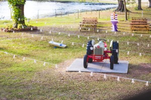 Outdoor String Lighting, Tractor, and Cocktail Decor at Outdoor, Rustic Bride and Groom Wedding Portraits | Rustic, Barn Wedding Ceremony | The Barn Crescent Lake at Old McMickey's Farm