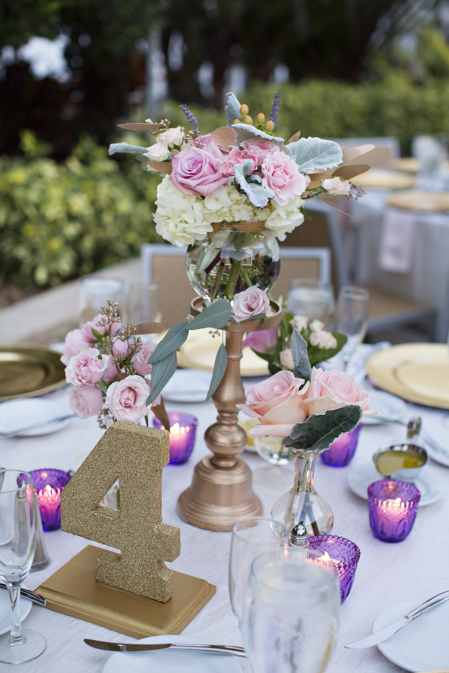 Romantic, Outdoor, Sarasota, Florida Wedding Reception Table Decor with Purple Tealight Holders, Gold Glitter Table Number and White and Pink Floral Centerpieces