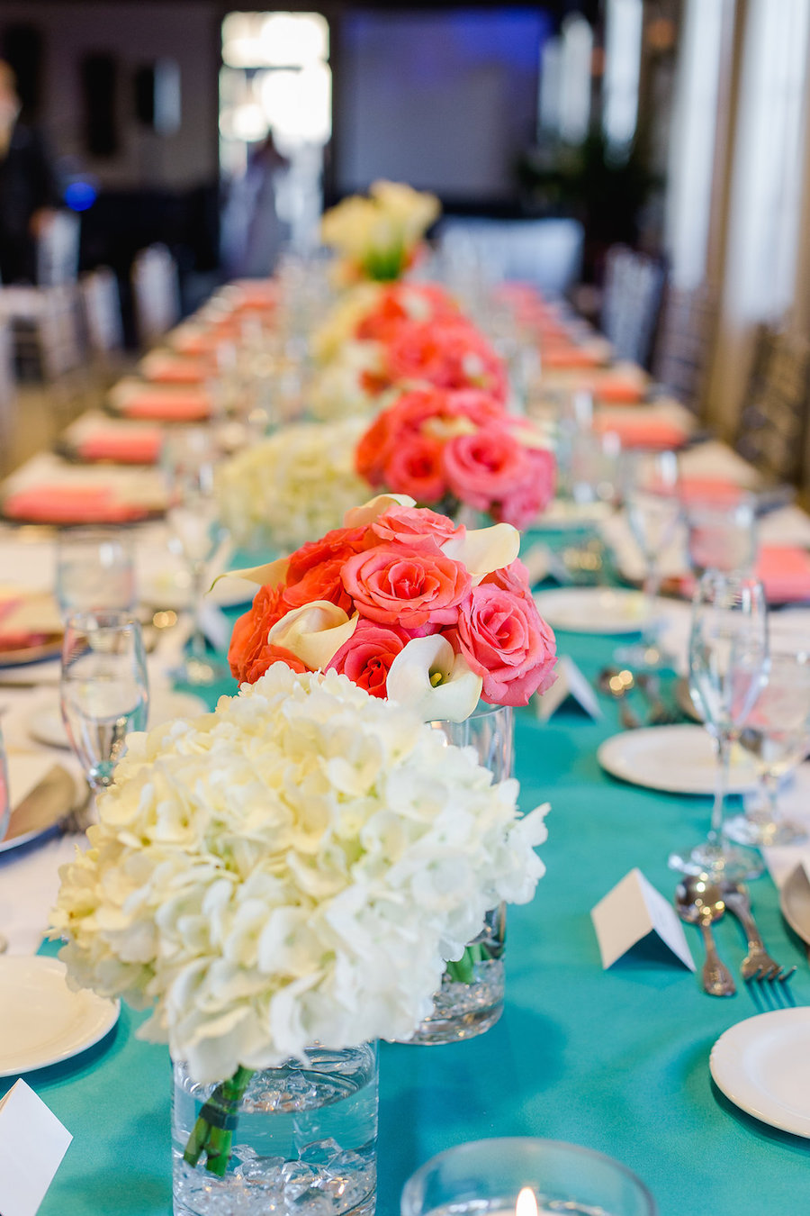 Teal and Coral Hydragena and Rose Wedding Centerpieces with Long Feasting Tables | Wedding Reception at The Club at Treasure Island