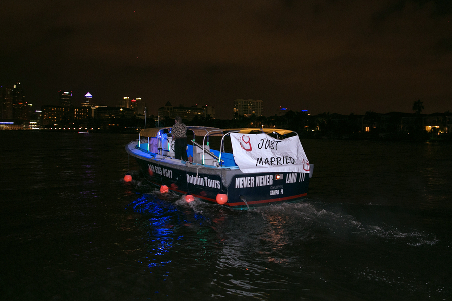 Tampa Bride and Groom Boat Sendoff with Just Married Sign | Waterfront Wedding Reception