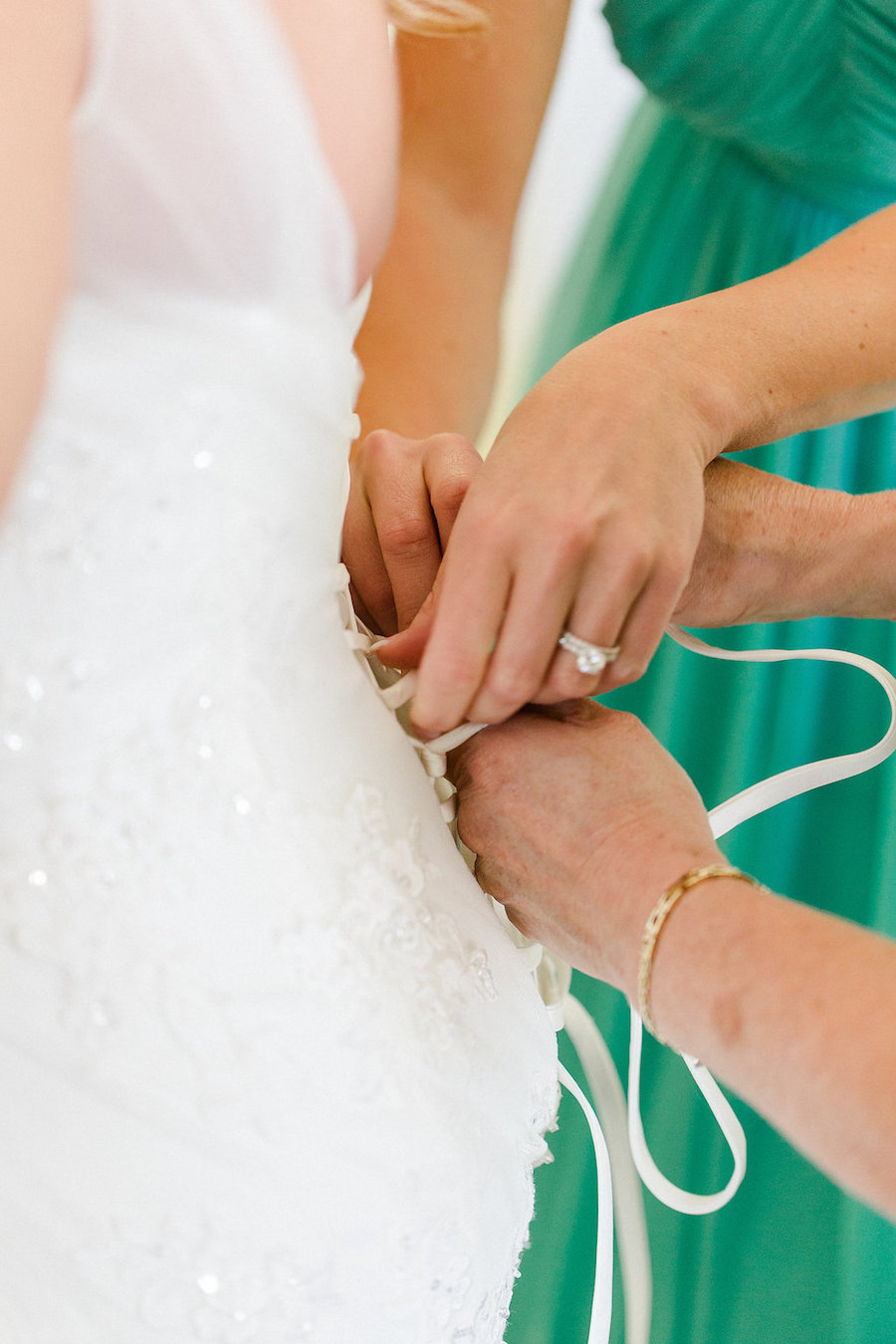 Bride Getting Ready Lacing Up Wedding Dress | St. Petersburg Wedding Photographer Ailyn La Torre Photography