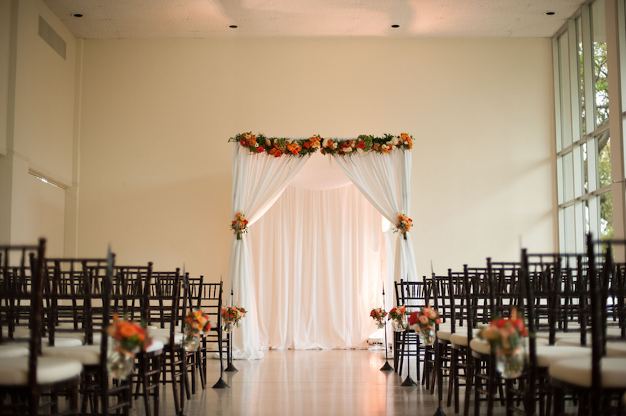 Tampa Garden Club Wedding Ceremony with Chiavari Chairs and White and Orange Draped Altar with Florals | Tampa Wedding Florist Andrea Layne Floral Design