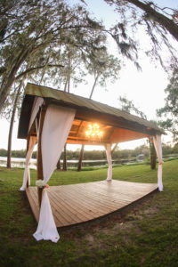 Outdoor Wedding Ceremony with Wooden Open-Air Barn with Chandelier and White Draping | Tampa Bay Wedding Venue The Barn at Crescent Lake at Old McMicky's Farm