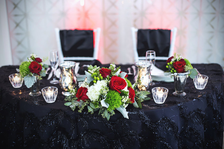 Tampa Wedding Reception Sweetheart Table with Black, Fringe Linen and Red, Ivory and Green Small Floral Centerpieces | Tampa Wedding Florist Apple Blossoms Floral Design