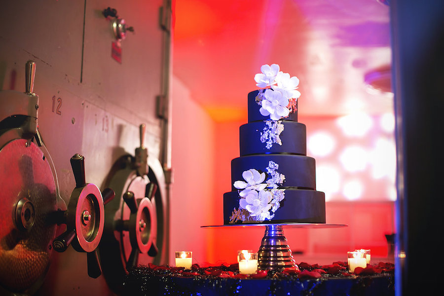 Four Tiered Black Wedding Cake with White Cascading Edible Flowers at Downtown Tampa Wedding Venue The Vault | Tampa Wedding Photographer FotoBohemia