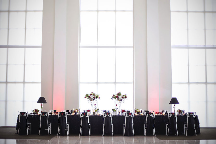 Downtown Tampa Wedding Reception with Black Linen, White Chiavari Chairs, and Red, Ivory and Green Centerpieces at the Vault | Tampa Wedding Photographer FotoBohemia