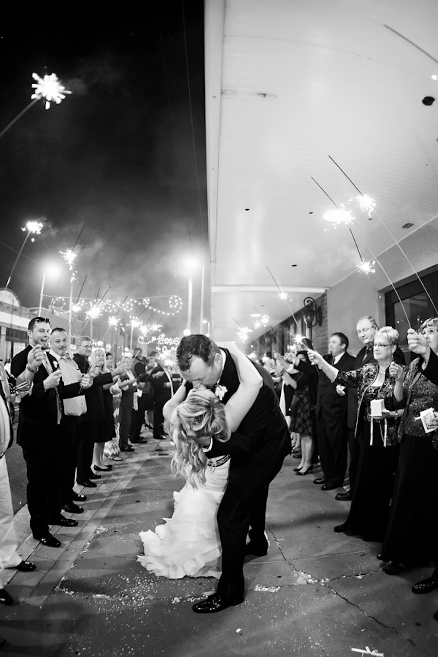 Bride and Groom Sparkler Send Off with Kiss