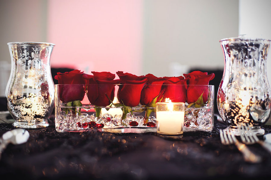 Reception Table Decor of Short, Red Roses and Tea Lights | Modern Black Linen, White Chiavari Chairs, and Red, Ivory and Green Centerpieces | Tampa Wedding Florist Apple Blossoms Floral Design