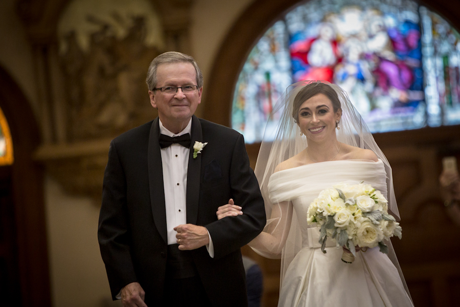 Bride and Dad Walking Down the Wedding Aisle Wearing off the Shoulder Justin Alexander Wedding Dress | Downtown Tampa Wedding Ceremony Venue Sacred Heart Catholic Church