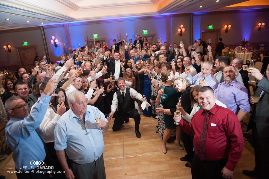 Tampa Bay Bride and Groom Group Photo with Guests at Wedding Reception | St. Petersburg Wedding DJ and Entertainment Celebrations24