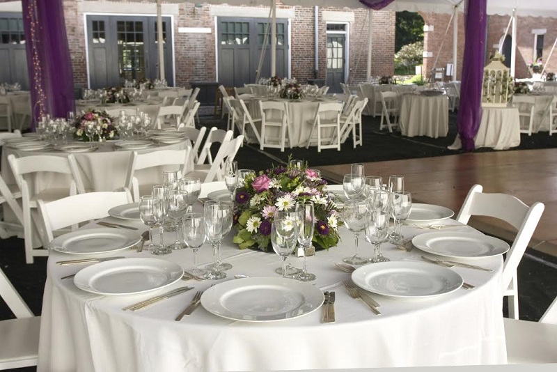 Tampa Bay Wedding Reception with White Linens, Dish Place Setting and White Folding Chairs | Pink Daisy Floral Wedding Centerpieces | St. Petersburg Wedding Rentals Rent-All City