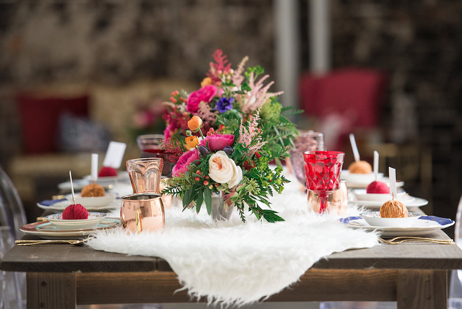 Wedding Reception Table Detail Including Copper Mugs and Yarn Placecard Holders | Tampa Bay Wedding Reception Decor at Tampa Bay Wedding Venue Rialto Theatre | White Fur Table Runner Rental from Tampa Bay Wedding Rental Company Kate Ryan Linens | Greenery and Vibrant Pink Flowers by Tampa Bay Wedding Florist Carrollwood Florist | Styled by Tampa Bay Wedding Designer Ever After Vintage Weddings| Tampa Bay Wedding Photographer Artful Adventures Photography