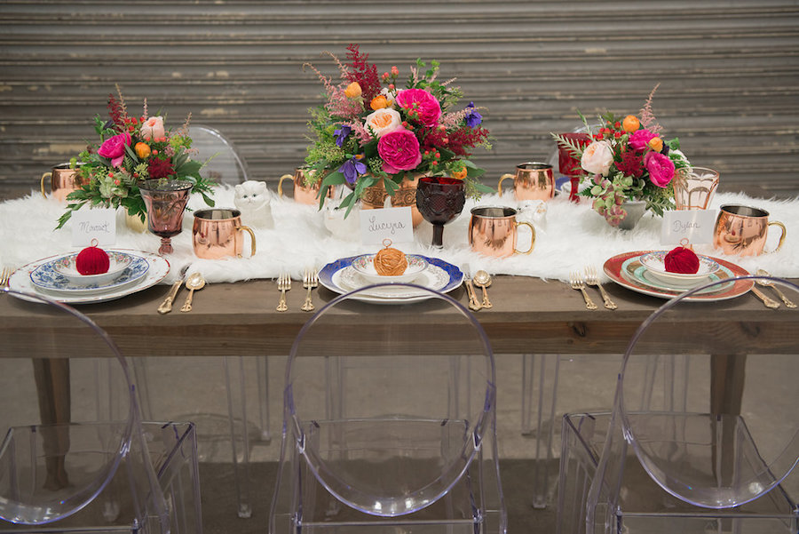 Cat Themed Wedding Reception Table Detail Including Copper Mugs and Yarn Placecard Holders | Tampa Bay Wedding Reception Decor at Tampa Bay Wedding Venue Rialto Theatre | White Fur Table Runner and Ghost Chair Rental from Tampa Bay Wedding Rental Company Kate Ryan Linens | Greenery and Vibrant Pink Flowers by Tampa Bay Wedding Florist Carrollwood Florist | Styled by Tampa Bay Wedding Designer Ever After Vintage Weddings| Tampa Bay Wedding Photographer Artful Adventures Photography