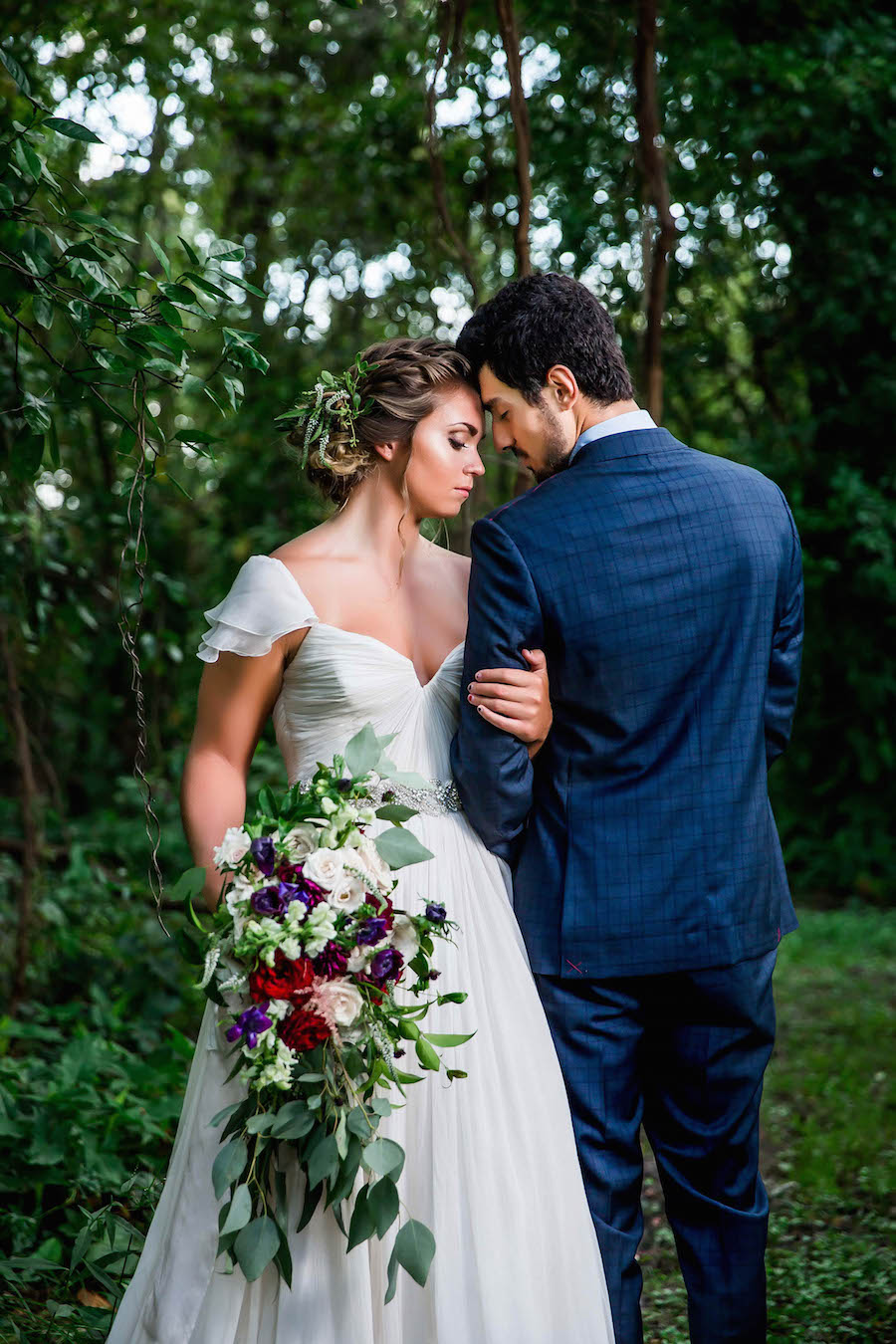 Bride wearing Amsale wedding dress from Blush Bridal Sarasota and Groom Portrait with Deep Red Burgundy Wedding Bouquet with Greenery | Southern Inspired Outdoor Wedding Reception Decor Styled Shoot