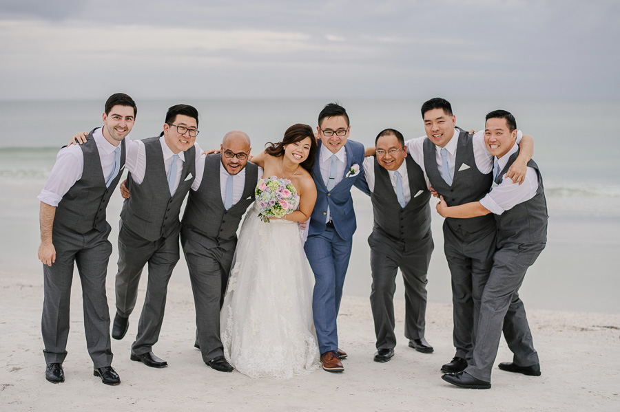Clearwater Beach Wedding Bride and Groom with Wedding Party Groomsmen in Three Piece Suit on Beach