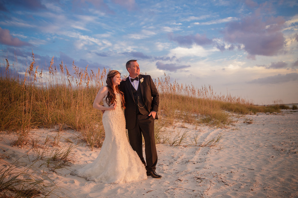 Destination Beach Bride and Groom Wedding Portrait at Sunset | Outdoor St Pete Beach Wedding at Loews Don CeSar | Kleinfeld Bridal Strapless Beaded Wedding Dress