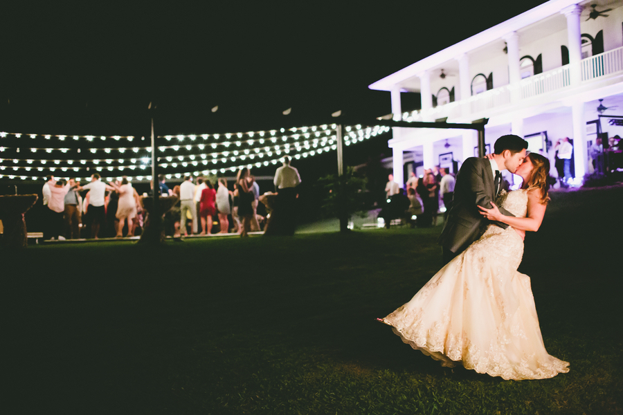 Bride and Groom Kissing Portrait | Outdoor Nighttime Wedding Reception with String Lighting | Outdoor, Rustic Tampa Bay/Dade City Wedding Reception Venue Barrington Hill Farm