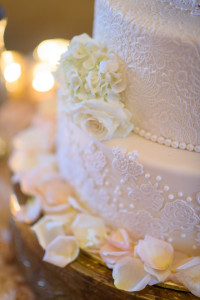 Elegant 4-Tier Round White Wedding Cake with Sugar Lace and Flowers